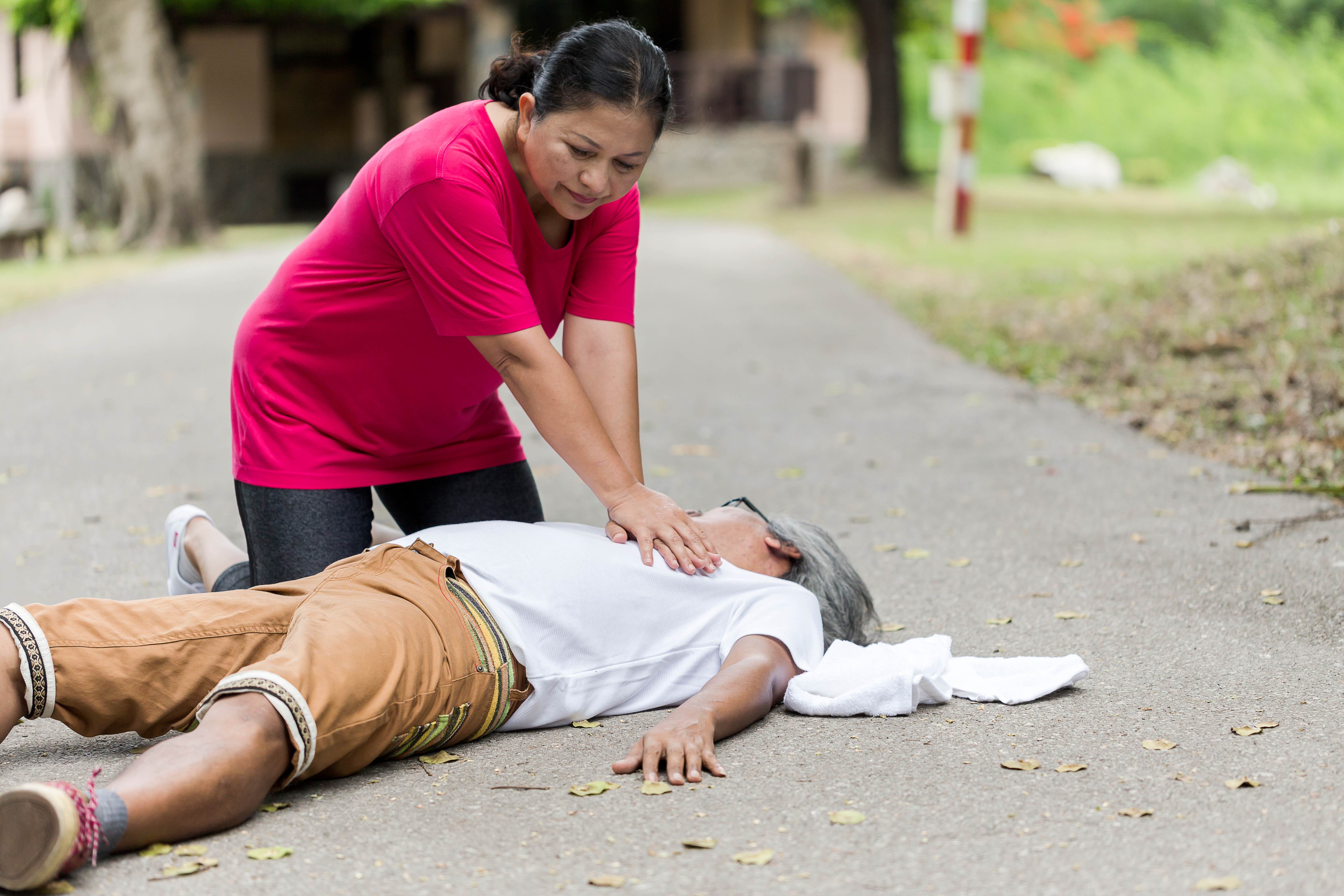 Person providing first aid for a heart attack.